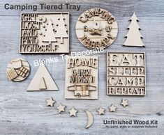 some wooden stamps that are on top of a wood table with the words camping treat tray