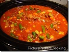 a crock pot filled with soup and vegetables