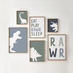 the wall is decorated with dinosaur silhouettes and typosaurus art on canvases