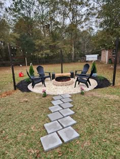 an outdoor fire pit surrounded by lawn chairs