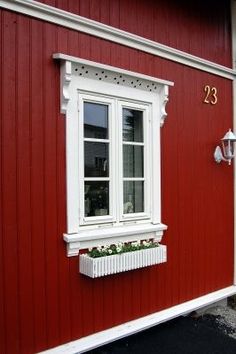 a red house with white trim and windows