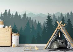 a child's room with a teepee tent and mountains in the back ground