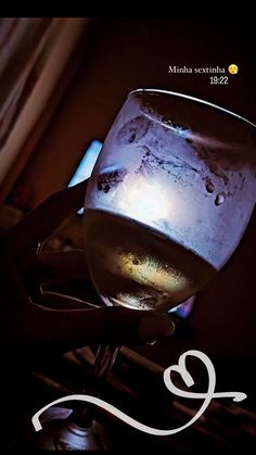 a glass filled with liquid sitting on top of a stove