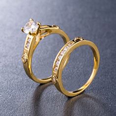 two gold wedding rings with diamonds on them