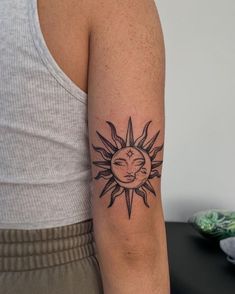 a woman with a sun tattoo on her arm