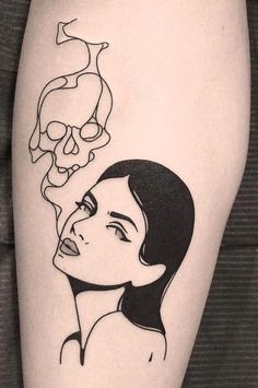 a woman's thigh with a skull on it and a drawing of her face