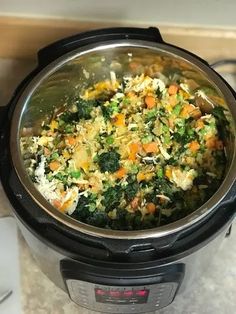 a crock pot filled with rice and vegetables