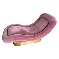 a pink couch sitting on top of a wooden stand