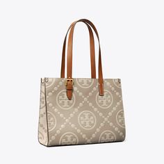 T Monogram is a classic pattern inspired by Pennsylvania Dutch quilting. The collection speaks to the timelessness of great style. The small tote is crafted in contrast-embossed leather. Each side features an inverse color combination, creating two looks in one. Lined in soft microsuede, the interior has pockets for organization. Every detail is considered, with special attention to function and versatility.Crafted in partnership with a Leather Working Group-certified tannery, supporting high st Carryon Bag, Tory Burch Kira Chevron, T Monogram, Ella Tote, Kira Chevron, Designer Tote Bags, Womens Designer Handbags, Designer Totes, Mini Tote Bag