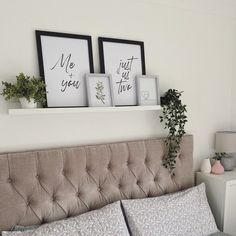 a bed with two framed pictures above it