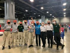 a group of people standing next to each other wearing face masks