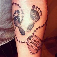 a person with a tattoo on their arm has a hand and foot print that reads, i am god