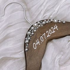 a wooden ornament with pearls on it that says h09704