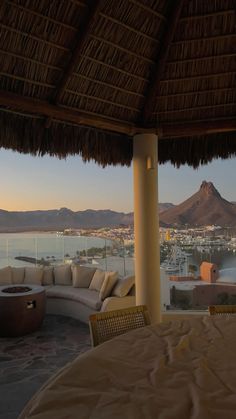 an outdoor seating area overlooking the water and mountains