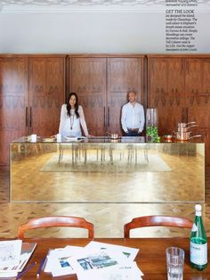 two people sitting at a table with papers on it