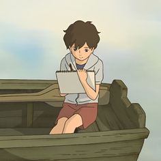 a boy sitting in the back of a wooden boat