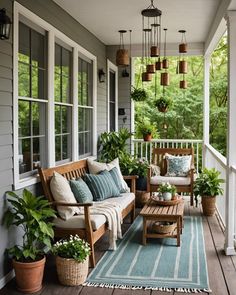 a porch with wooden furniture and plants on it