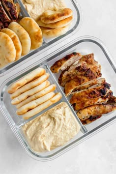 two plastic containers filled with chicken, pita bread and hummus next to each other