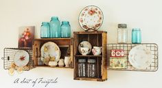 an old wooden shelf with plates and dishes on it, next to other vintage items