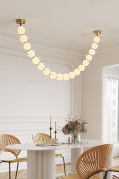 a white dining room with chairs and a table