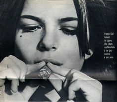 a woman with her hand on her mouth and holding a ring in front of her face