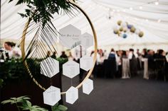 an image of a wedding reception in a marquee with greenery and seating