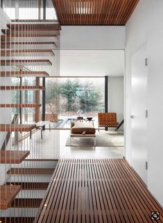 the inside of a house with wooden stairs