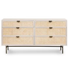 a white dresser with four drawers and wicker handles