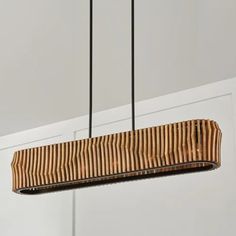 a wooden light fixture hanging from a ceiling