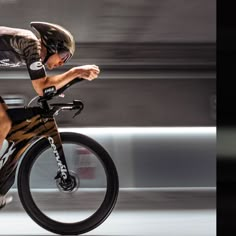 a man riding on the back of a bike while wearing a bib and helmet