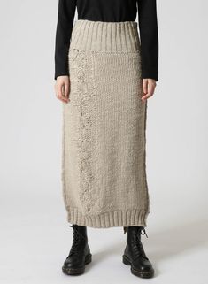 This long tight-fitting knit skirt with a back slit has a textured pattern and a relaxed feel. Made with a combination of slub and polyester yarn, it offers a chunky, three-gauge knit for a voluminous look. It shapes a feminine silhouette and pairs well with various tops, including the matching one. - Features a bold, stylish back slit. - Knit with slub and polyester yarn for a textured design. - Three-gauge knit creates a chunky, relaxed feel. - Comfortable fit, accentuating a feminine silhouet Feminine Silhouette, Polyester Yarn, Knit Skirt, Comfort Fit, Tights, Pattern, Design