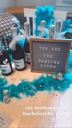 there is a sign that says you are the dancing queen next to bottles of booze