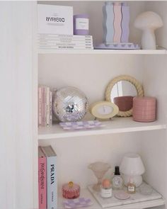 a white book shelf filled with books and other items