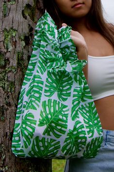 Monstera Pattern Medium Lei Bag - 100% rPET World's first original Hawaiian Lei Bag, now available in 100% rPET (derived from recycled Polyethylene Terephthalate, transforms waste PET from both businesses and consumers). As of January 2024, all Citadine reusable bags are crafted exclusively with 100% rPET rip-stop material, aligning with our sustainability objectives. The use of French Seam ensures a cleaner, prettier, and stronger interior, emphasizing our commitment to superior quality. Each b Lei Purse, Flowers Of Hawaii, Monstera Pattern, Hawaiian Lei, 50 Pounds, Love And Happiness, Polyethylene Terephthalate, Forever Living Products, January 2024