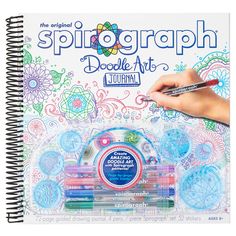 the original spiral graph doodle art journal is shown with markers and pencils in it