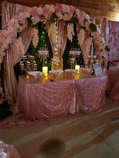 the table is set up with candles and flowers on it for an elegant wedding reception