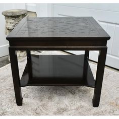 a black table sitting on top of a rug