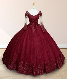 Step into a fairytale with this Glitter Long Sleeve Princess Burgundy Quinceanera Dress. This dress is crafted from luxurious lace fabric and features long sleeves for an added touch of elegance and sophistication. The scoop neckline frames your face beautifully, while the corset back ensures a tailored fit, enhancing the gown’s regal silhouette. The enchanting burgundy hue and glittering sequin embellishments create a dazzling effect, perfect for a royal-inspired look. With intricate appliques Quince Dresses Sleeves, Burgundy Sweet 16 Dresses, Red Quinceanera Dresses With Sleeves, Wine Red Ball Gown, Maroon Quinceanera Dresses, Burgundy Quinceanera Theme, Dark Red Quinceanera Dresses, Gryffindor Dress, Long Sleeve Quinceanera Dresses