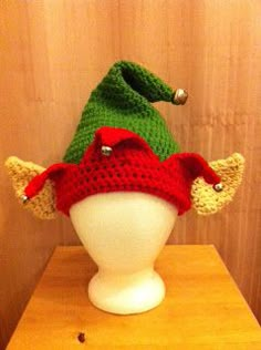 a crocheted elf hat sitting on top of a white mannequin head