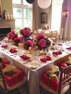 a dining room table is set with pink flowers and gifts for the holiday dinner party