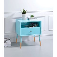 a blue nightstand with a plant on top