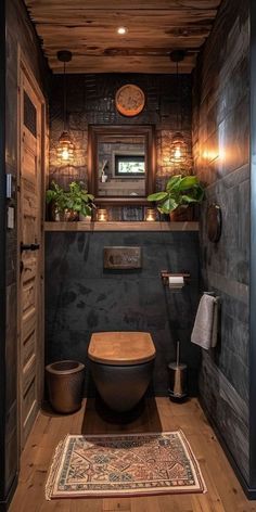 a rustic bathroom with wood paneling and black walls