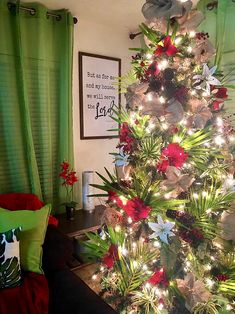 a decorated christmas tree with red and white flowers