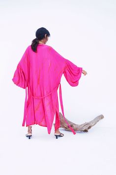 An impressive statement piece, the Miko - Fuchsia Kimono Robe & Jacket is as luxurious as it is versatile. With its chic Fuschia hue, this sophisticated piece can easily elevate any look. Ideal for a sophisticated night out, wear this jacket over a jumpsuit or little black dress and heels. Features: Soft feel Lightweight feel Very comfortable Handmade Oversized fit Puffy sleeves Oversized -One size all fit Removable waist tie closure with loops Side slits at hem No pockets Hand wash in cold wate Pink Party Kimono, Fitted Pink Summer Kimono, Pink Spring Party Kimono, Spring Party Pink Kimono, Pink Kimono For Fall Vacation, Pink Long Sleeve Kimono For Party, Chic Pink Kimono, Pink Fall Vacation Kimono, Fitted Pink Kimono