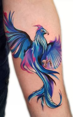 a colorful bird tattoo on the left arm and leg, it is blue with purple wings