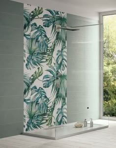 a bath room with a large mirror and a plant print wallpaper on the wall