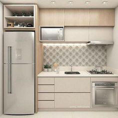 a kitchen with a refrigerator, stove and sink in it's cabinetry area