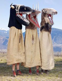 two people dressed in animal costumes with their mouths open and teeth out, standing next to each other