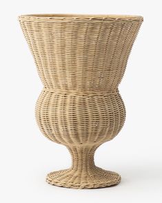 a large wicker vase sitting on top of a table