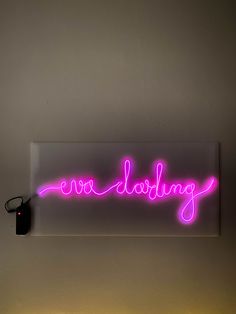 a neon sign that reads, one do something on it's side in front of a white wall